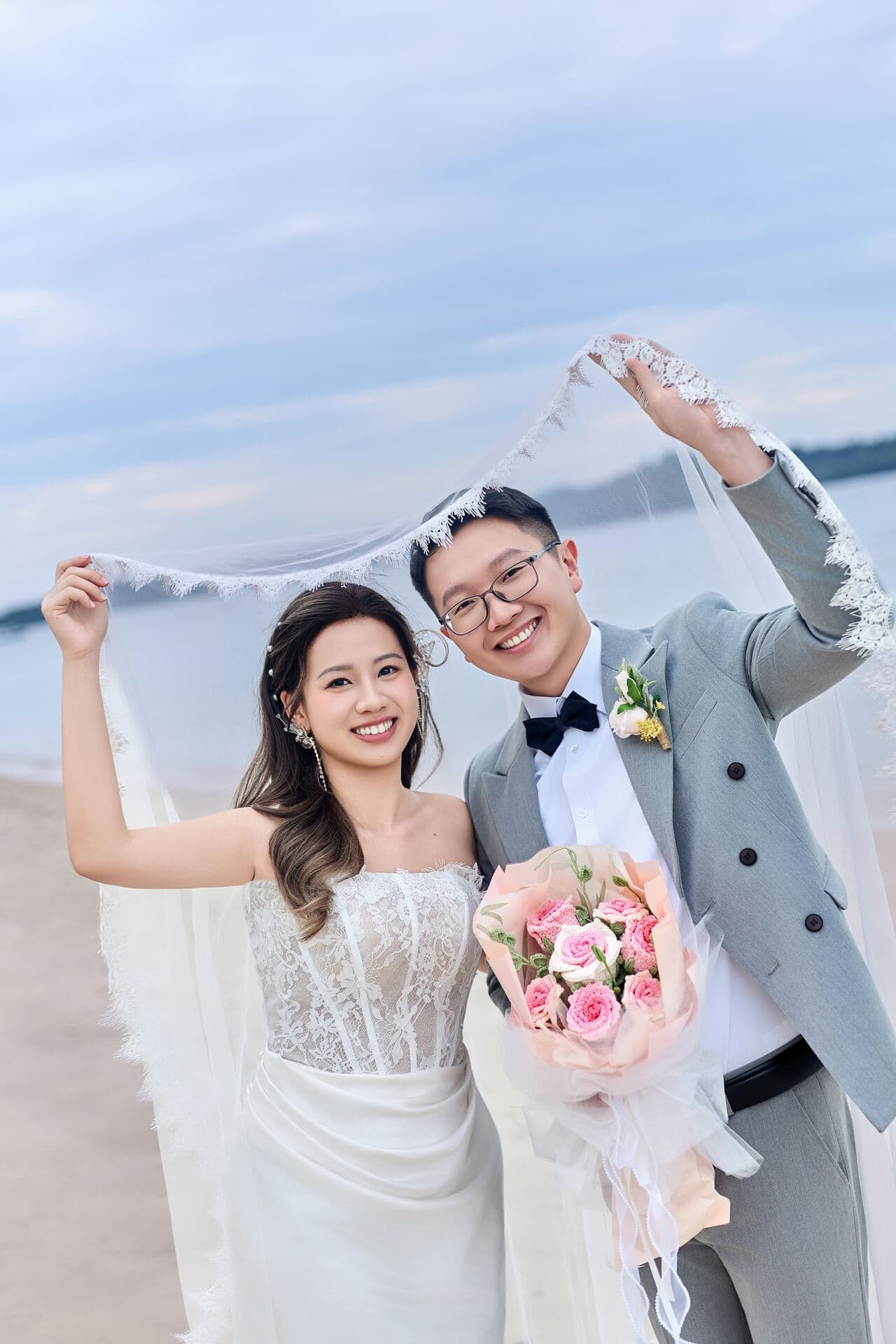 Couple with bouquet on the beach